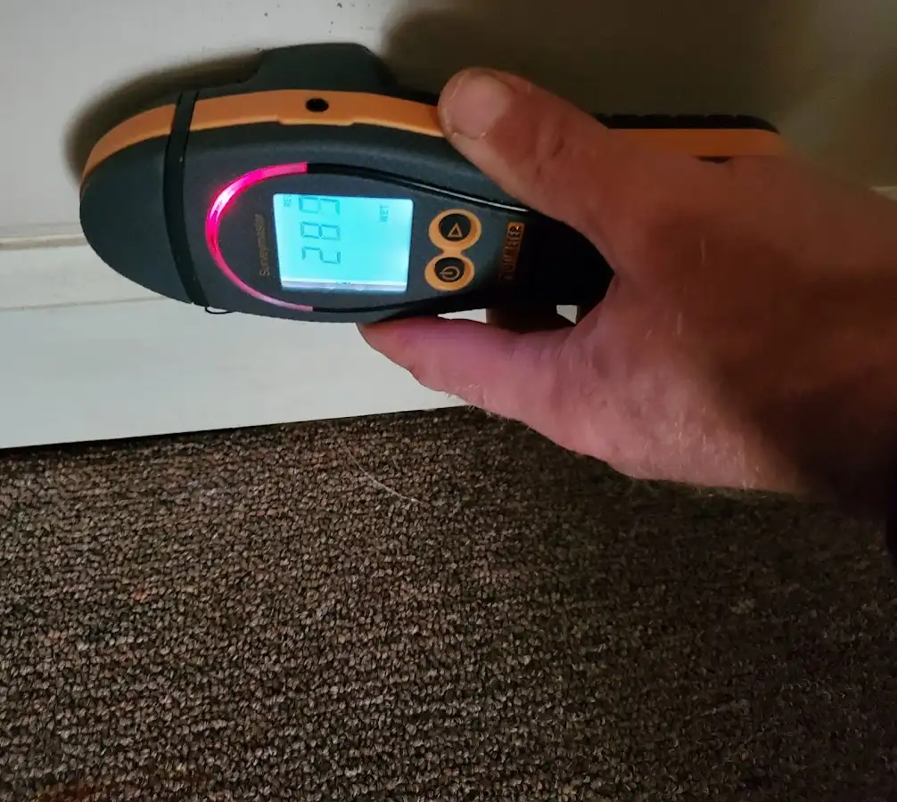 Moisture detection at baseboard during Storm Damage Restoration in Dalton